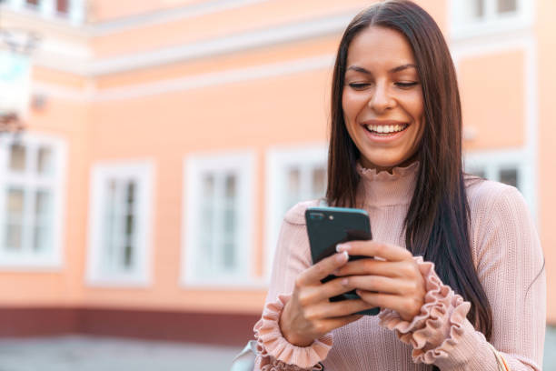 istock Young attractive woman typing on her cellphone 1531174296