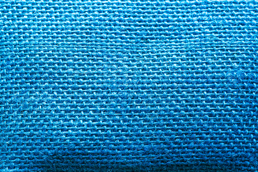 blue texture texture macro,close up texture of creased fabric. blue woolen fabric. blue wavy cloth background showing fiber detail. blue fabric background with beautiful light and shadow.