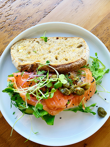 Open sandwich of smoked salmon, watercress, rocket, seeds, capers and more.