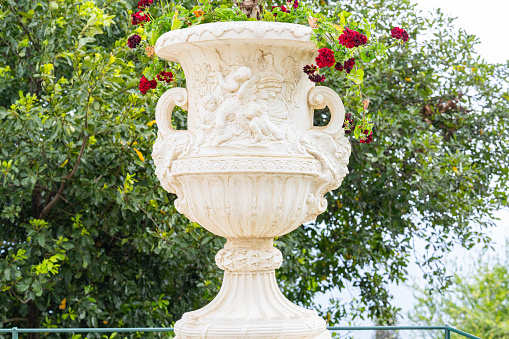 stone vase with flowers in the park