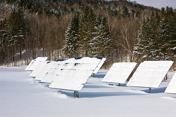 Field of snow covered solar panels stock photo