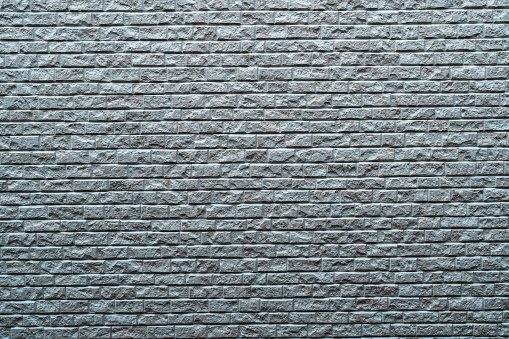 Construction details, gray brick wall background