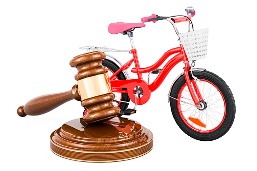 Wooden gavel with kids bicycle. 3D rendering isolated on white background