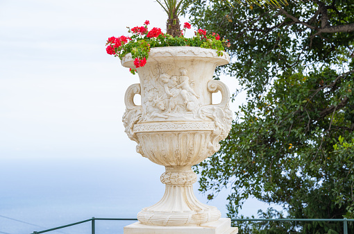 stone vase with flowers in the park