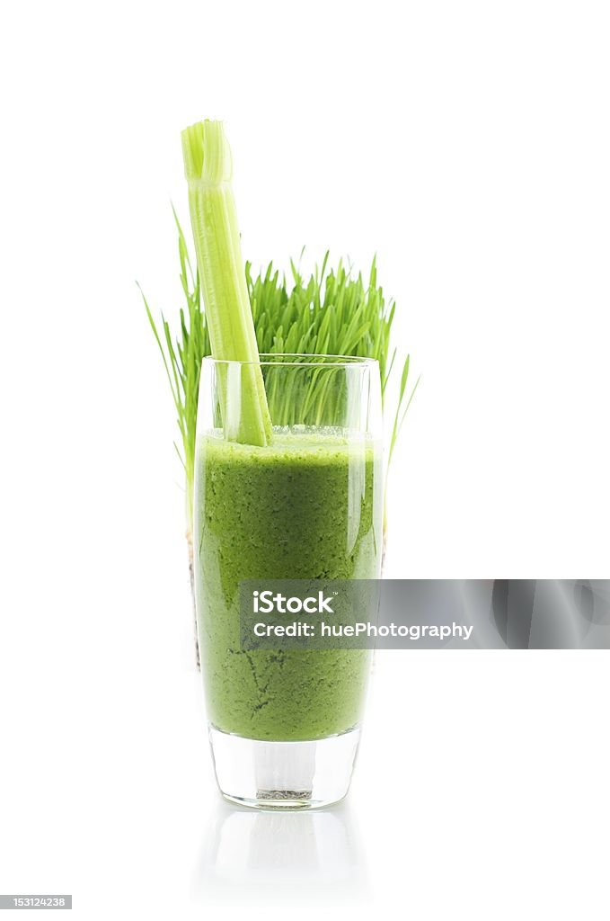 Fresh wheat grass smoothie isolated on white background Wheat grass smoothie, with celery stick, and wheat grass plant in background. Isolated on white. Juice - Drink Stock Photo