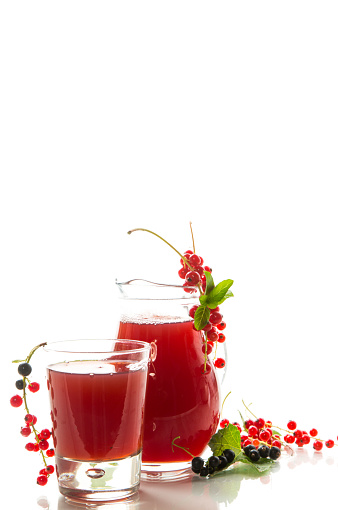 fresh berry juice from red and black currant, isolated on white background
