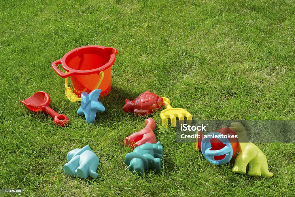 Garden Playtime Fun Description: An Assortment of childrens toys taken in a garden. Dinosaur Stock Photo