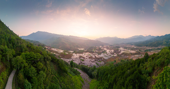 Aerial view of the pouring water season makes the terraced fields of Y Ty commune, Lao Cai province appear with brown soil blending with the beautiful sky. Travel and landscape concept in North West Vietnam
