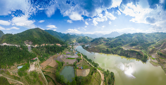 Aerial view of the pouring water season makes the terraced fields of Y Ty commune, Lao Cai province appear with the beautiful sky. Travel and landscape concept in North West Vietnam