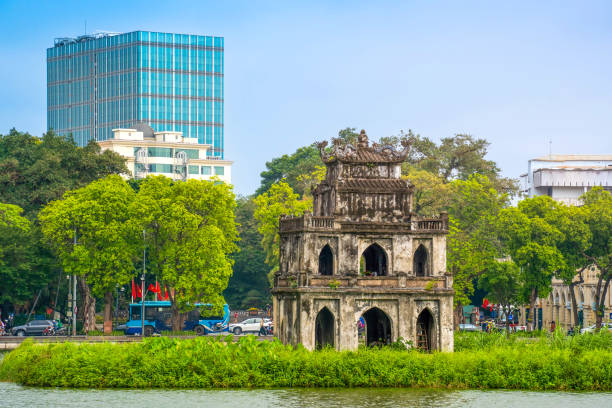 Hoan Kiem Lake ( Ho Guom) or Sword lake in the center of Hanoi in the morning. Hoan Kiem Lake is a famous tourist place in Hanoi. Travel and landscape concept. Hoan Kiem Lake ( Ho Guom) or Sword lake in the center of Hanoi in the morning. Hoan Kiem Lake is a famous tourist place in Hanoi. Travel and landscape concept. Selective focus. ho guom stock pictures, royalty-free photos & images