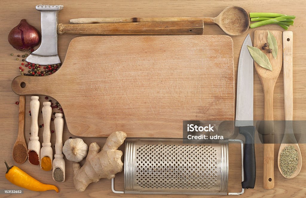 Vegetables and spices with empty cutting board Vegetables and spices border and empty cutting board with kitchen equipment Blank Stock Photo