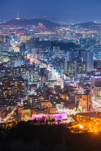 Aerial view over the illuminated sunset cityscape of central Seoul, South Korea’s vibrant capital city.