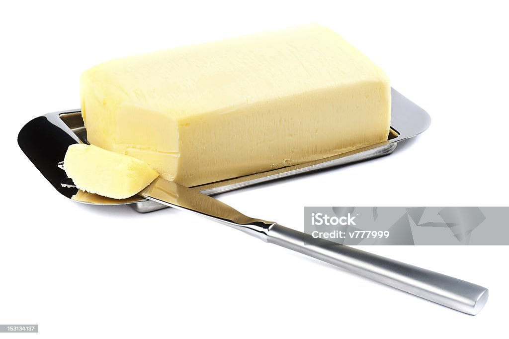 Stick of butter with a corner sliced off Piece of Butter on Silver Plate with Knife. Butter Stock Photo