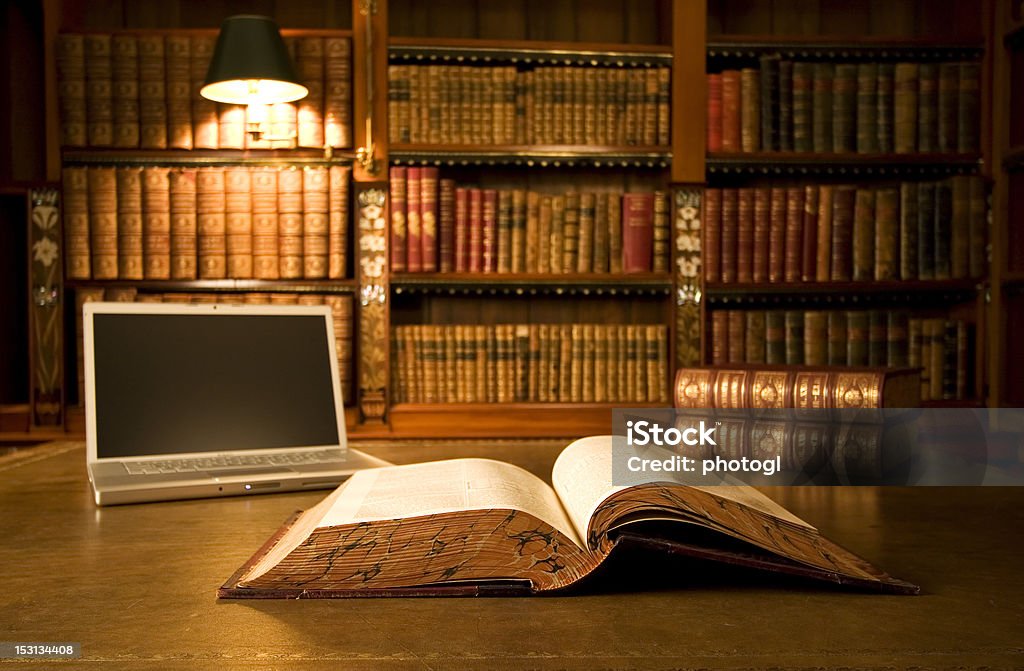 Laptop in classic library Laptop in classic library with books in background series Law Stock Photo