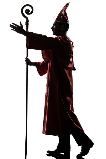 istock man cardinal bishop silhouette saluting blessing 153134783