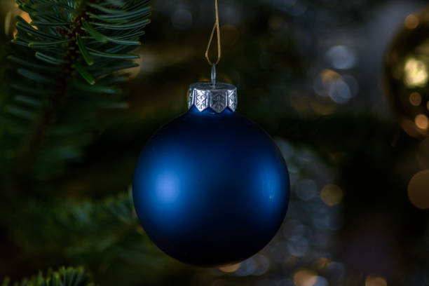 istock blue christmas ball in christmas tree 1531356205