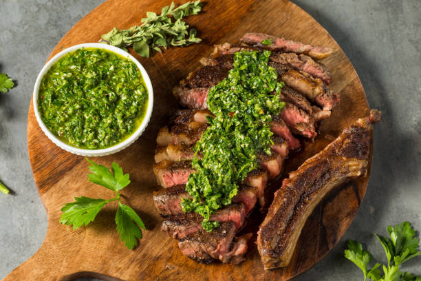 Homemade Chimichurri Sauce and Ribeye Steak Homemade Chimichurri Sauce and Ribeye Steak with Garlic chimichurri stock pictures, royalty-free photos & images