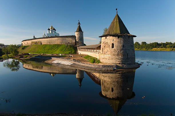 Pskov Kremlin Ancient castle at dawn reflected in the water. The confluence of the Great and Pskov pskov city stock pictures, royalty-free photos & images