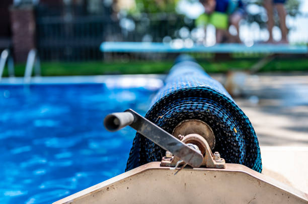 Manual real for a retractable floating pool cover to keep out leaves and keep in heat. . High quality photo