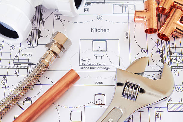 Plumbing Tools Arranged On House Plans Planning new kitchen build blueprint industry work tool planning stock pictures, royalty-free photos & images