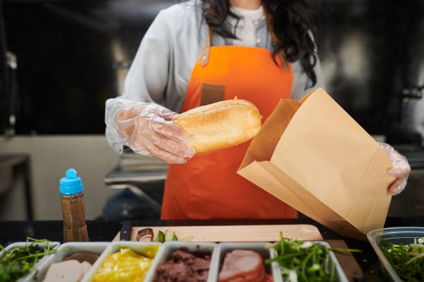 istock Food Truck Worker Packing Sandwich 1531408147