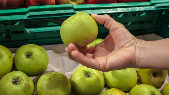 Experience the process of selecting the perfect apple at a vibrant supermarket. Accompanied by a discerning woman, this video captures the careful consideration given to each choice. With a focus on health and well-being, she navigates the aisles, handpicking fresh and nutritious apples. As a conscious consumer, she explores the variety of options available, ensuring she makes the best purchase. Join her on this journey through the bustling market, where the retail industry thrives and small businesses flourish. Witness the actions of a health-conscious individual as she makes informed decisions in the pursuit of a balanced lifestyle.