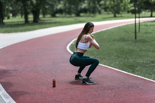 Drinks Keeping Beautiful Female Hydrated While Working Out In Park
