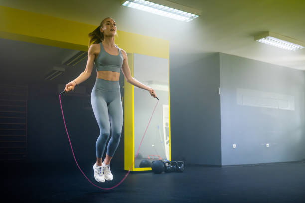 istock Young woman jumping over rope 1531437539