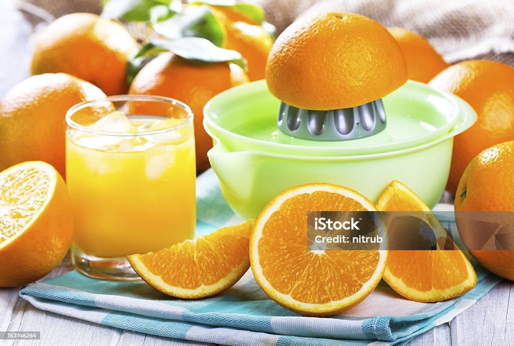 fresh oranges with juice fresh oranges with juice and squeezer Agriculture Stock Photo