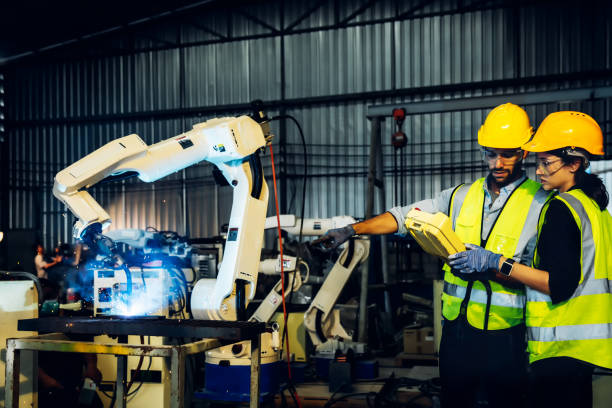 istock Engineer or Worker in intelligent factory industrial. Engineer check and control automation robot arms machine in intelligent factory industrial 1531467892