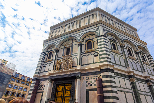 Florence, Italy - May 9, 2023 .Florence Baptistery in front of the Duomo in Florence, Italy