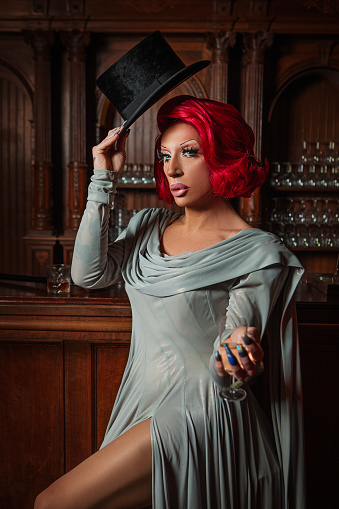 A beautiful elegant 1920s style redhead drag queen in a luxury stately home