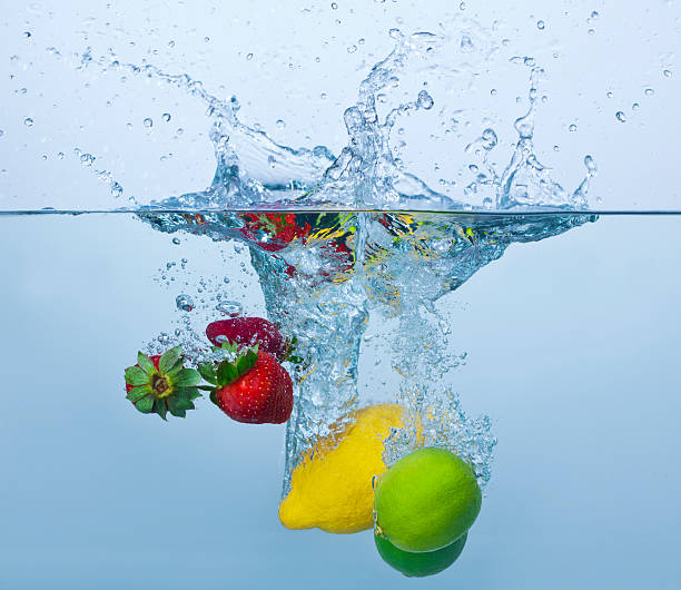 istock Strawberries, lemon and limes splashing in water 153148006