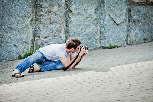 Photographer in action on a floor