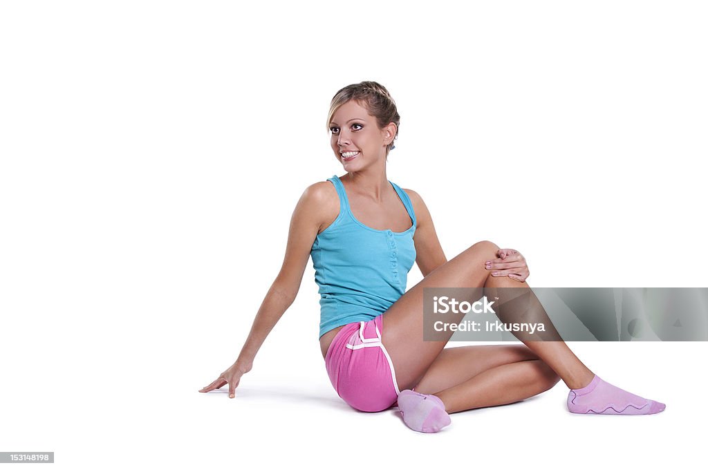 woman doing stretching exercises Young fitness woman doing stretching exercises. Isolated on white Activity Stock Photo