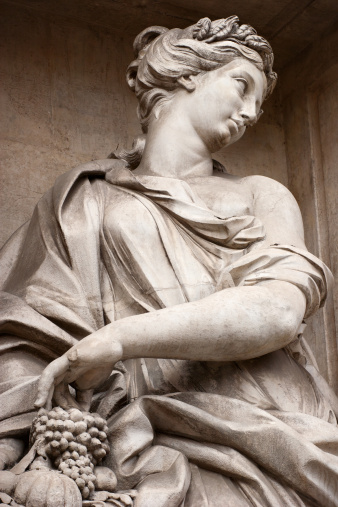 Statue of a Woman with Grapes at Trevi Fountain in Rome