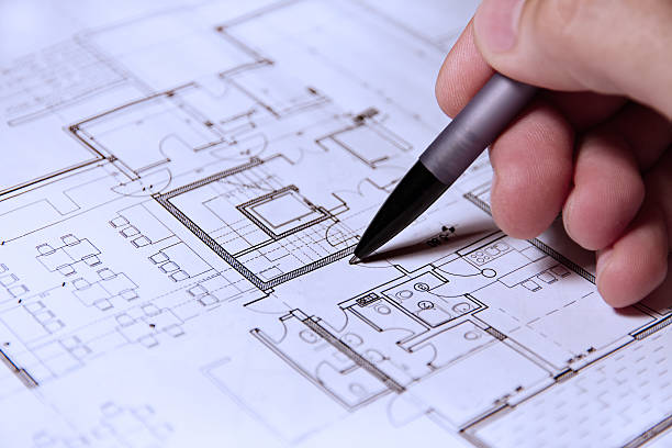 istock Pencil in hand on building plans 153148445