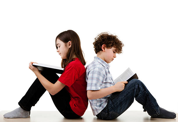 Kids reading books Back to school - boy reading book isolated on white background boy and girl reading stock pictures, royalty-free photos & images