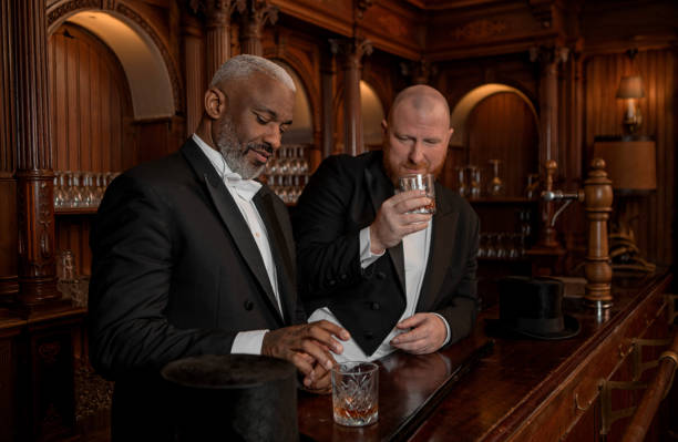 istock Two handsome 1920s style gentlemen in a luxury brown bar 1531486576