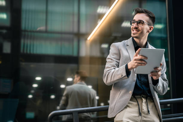 istock Young happy businessman using digital tablet outside of modern work place 1531486937