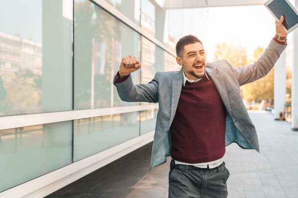 istock Young successful businessman running while holding digital tablet outdoors 1531487151
