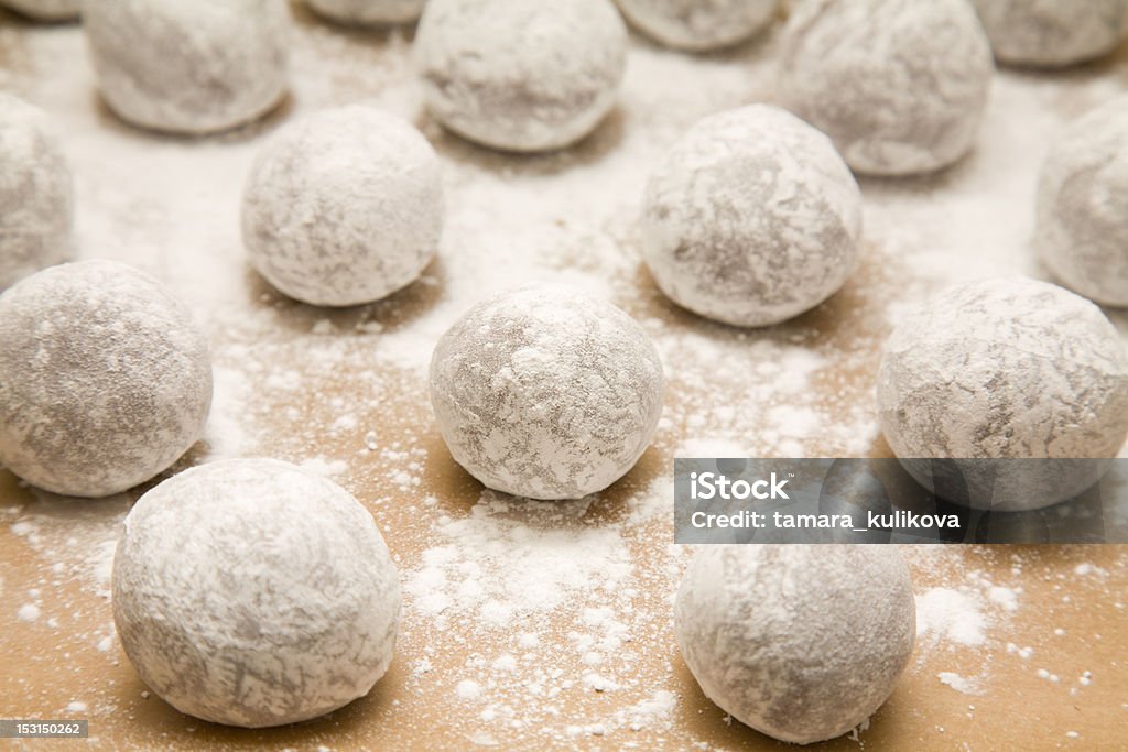 chocolate dough tray of  chocolate dough balls with icing sugar dusting (making cookies) about to go into oven Baking Stock Photo