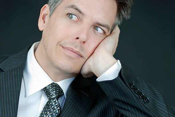 istock Businessman Looks At Camera While Ressting Head In Hand 153150624