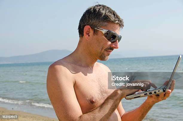 Man Relaxing On The Beach With His Notebook Stock Photo - Download Image Now - Adult, Beach, Business