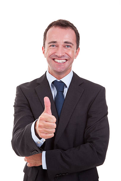 handsome businessman with thumb raised as a sign of success stock photo
