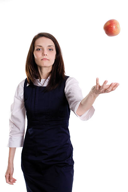 istock Mid-aged woman throwing apple in the air 153153928