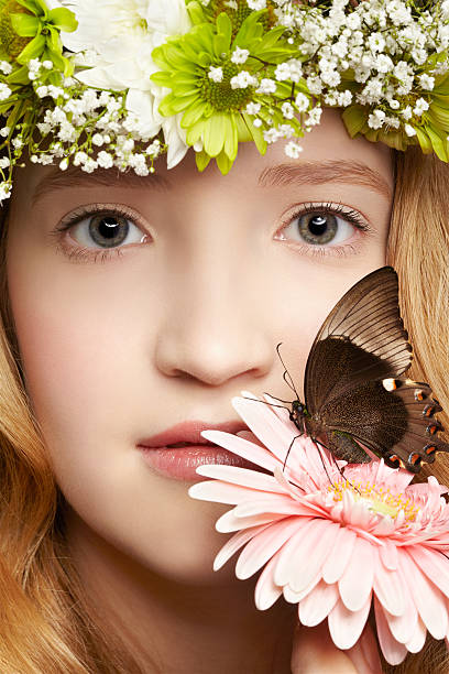 beautiful girl and butterfly closeup portrait of beautiful healthy redhead teen girl with butterfly on gerbera flower papilio palinurus stock pictures, royalty-free photos & images