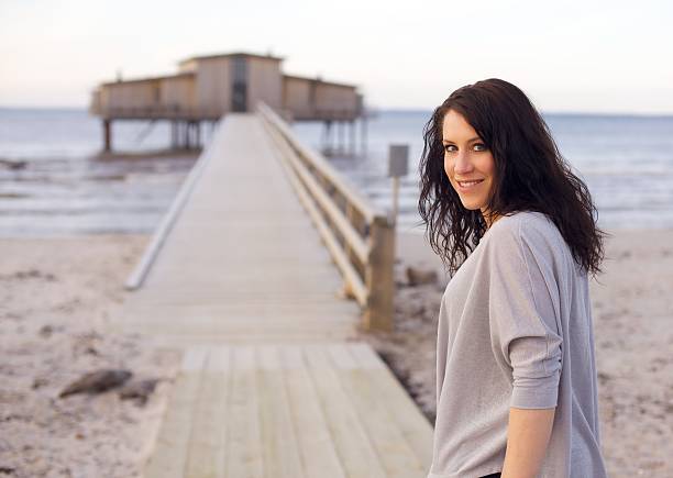 istock Woman on an Idyllic Beach Facing the Camera 153155397
