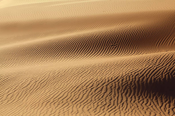 istock Sandy waves are poured in solar beams 153155890