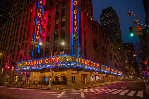 Radio City Music Hall at night during pandemic. The Radio City Music Hall is an entertainment venue and theater at 1260 Avenue of the Americas, within Rockefeller Center, in the Midtown Manhattan neighborhood of New York City